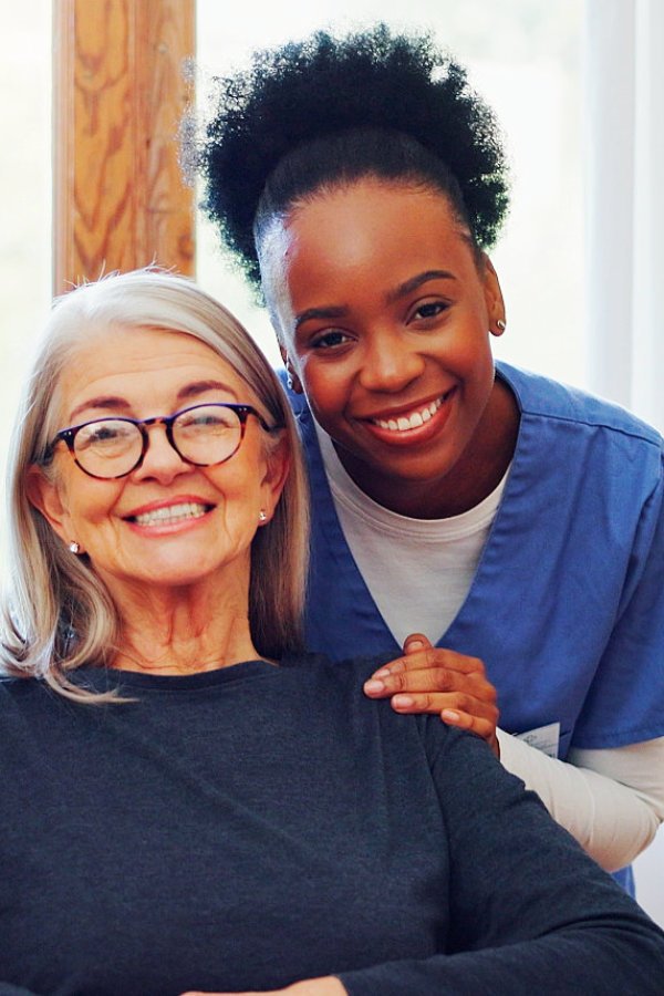 caregiver and her patient smile on the camera