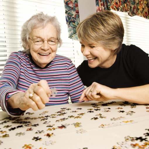 caregiver and her patient play a puzzle