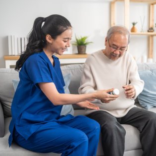 caregiver explain the medication to her patient