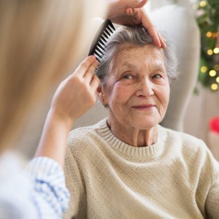 caregiver comb her patient's hair