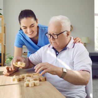 caregiver and her patient play a puzzle