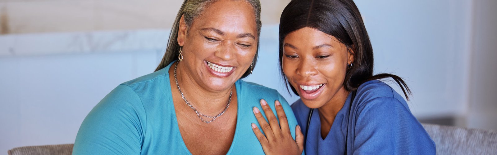 caregiver and her patient use laptop to answer a call